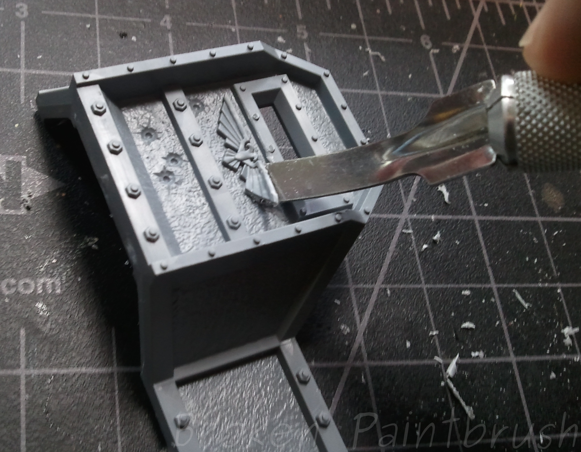 Using an X-Acto Chisel blade to remove Aquila